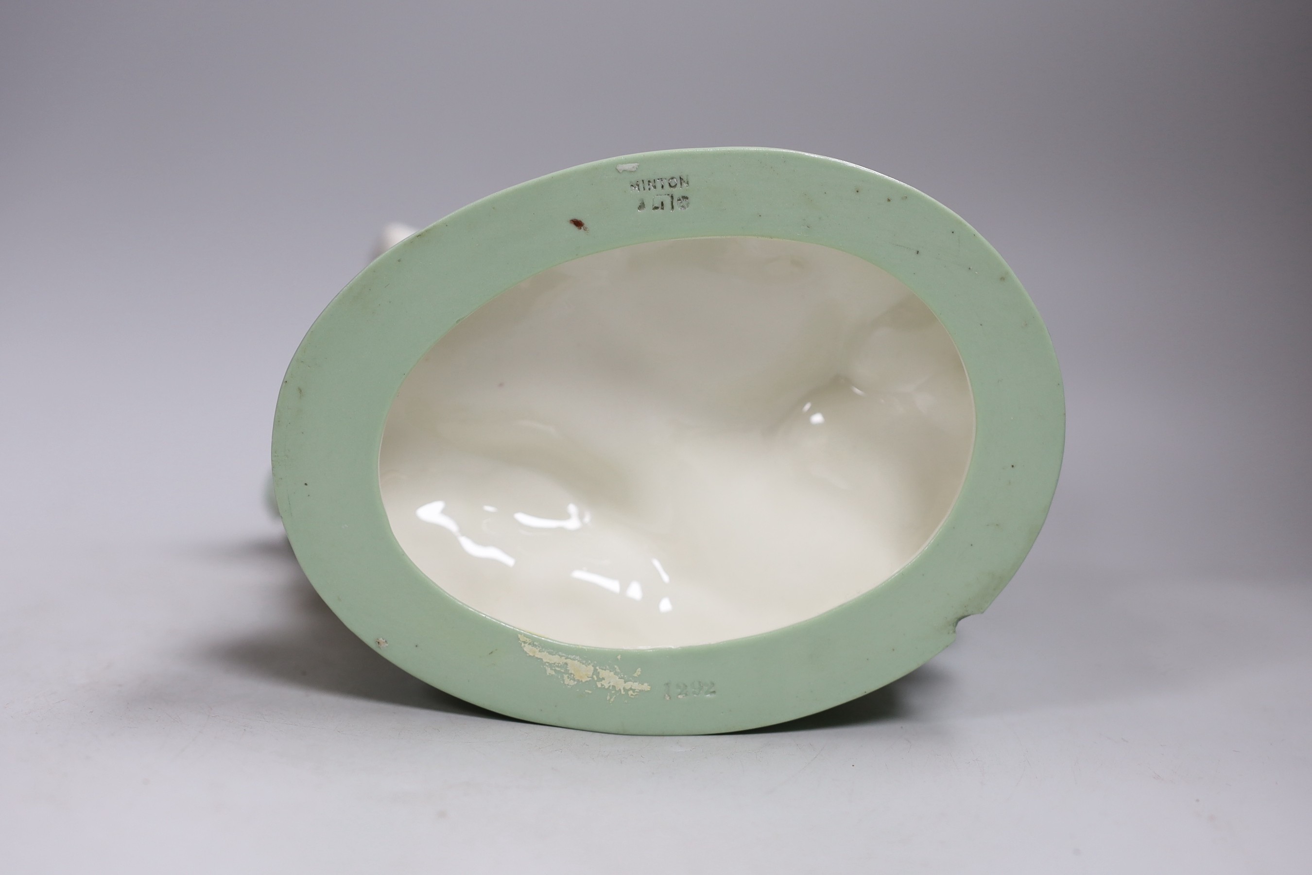 A 19th century Minton celadon glazed figure of a mermaid with a shell on her back, 21cm tall